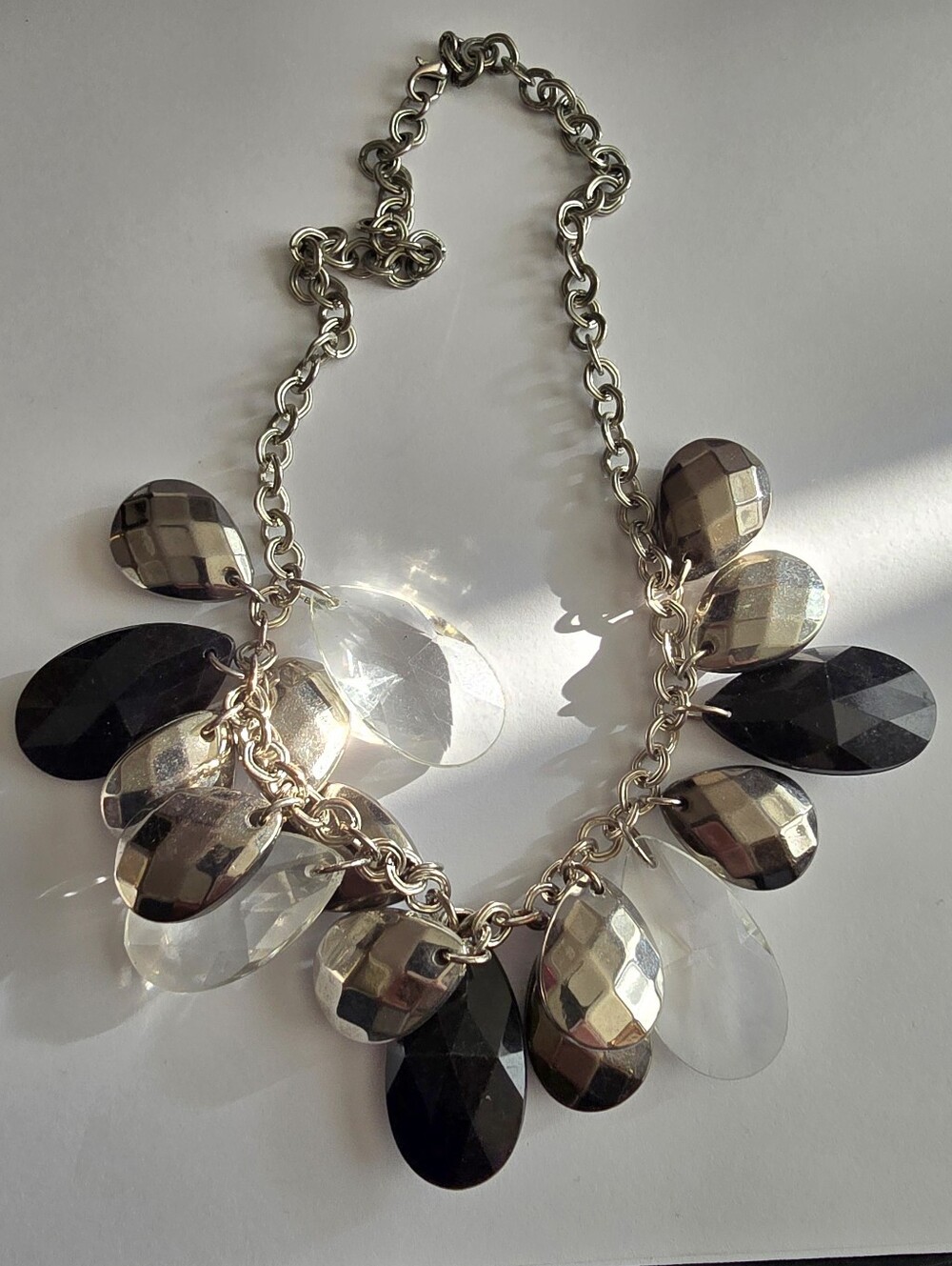 Necklace with chunky teardrop pendants charms silver tone black and clear